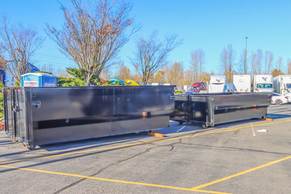 Professional dumpster rental service with roll-off container on residential driveway in Burrillville